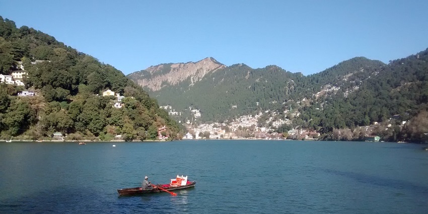Scenic lake surrounded by hills, perfect for boating activities.
