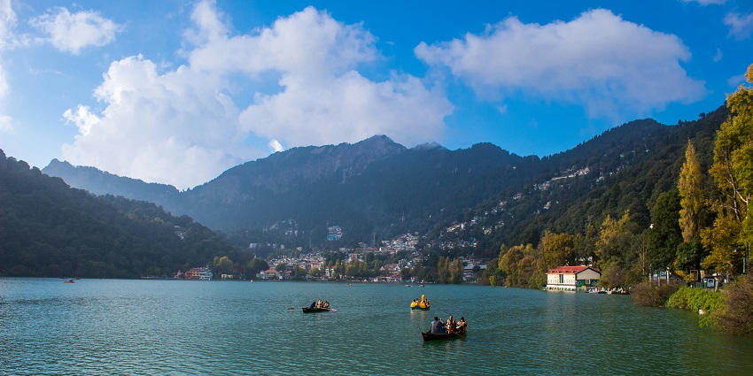 People rowing boats together on a peaceful river - places to visit in Uttarakhand in April