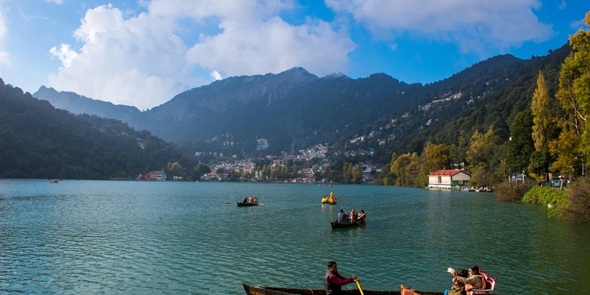 A serene view of Nainital featuring shimmering lakes, majestic mountains and more.