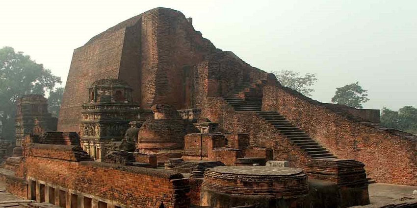 Ruins of early Nalanda University and its vast structure with stairs leading to the top.