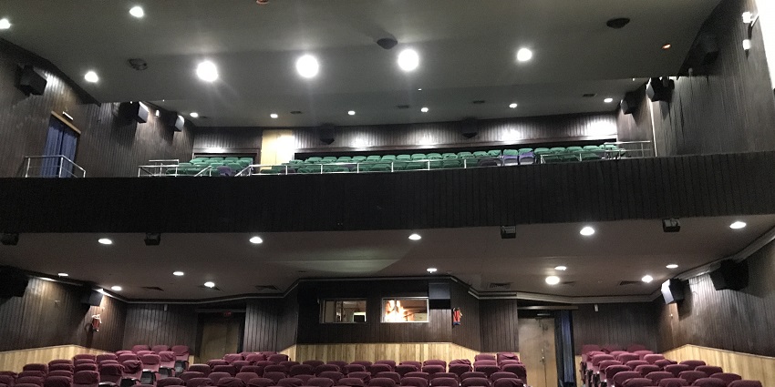 An interior shot of audience seats in a theatre in Kolkata, West Bengal, India.