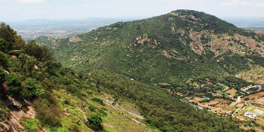 A verdant view of the Nandi Hills with lush green landscapes and rolling hills in the day.