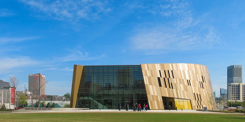 The National Center for Civil and Human Rights encompassed by grass and other buildings