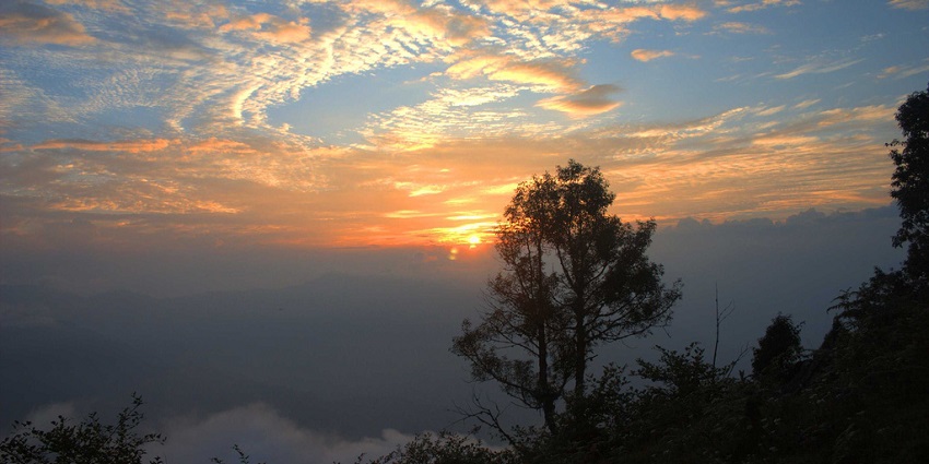 Experience a captivating sunset in Neora Valley which is home to rich biodiversity.