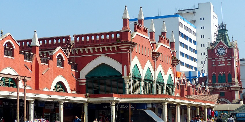 A glimpse of the iconic New Market featuring a red building and vendors selling books.