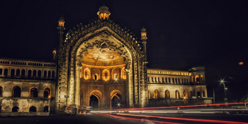 Night view of Rumi Darwaza in Lucknow, showcasing its intricate Mughal architecture.