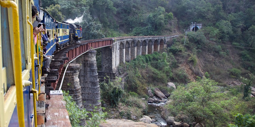 An image of The Nilgiri Queen cog-drive steam train getting into a tunnel, one of the tourist attractions in Ooty