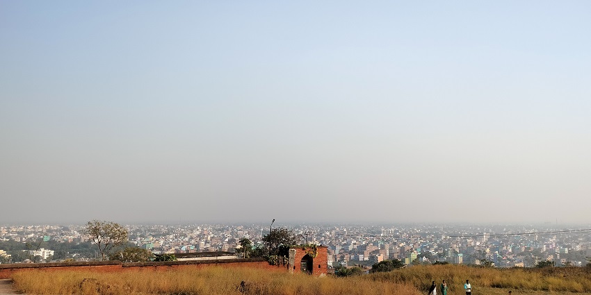 Bihar Sharif City from Bari Pahari with fields, ancient structures, and buildings in view.