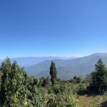 A picture taken at a mountain filled with lush greenery, capturing a scenic view