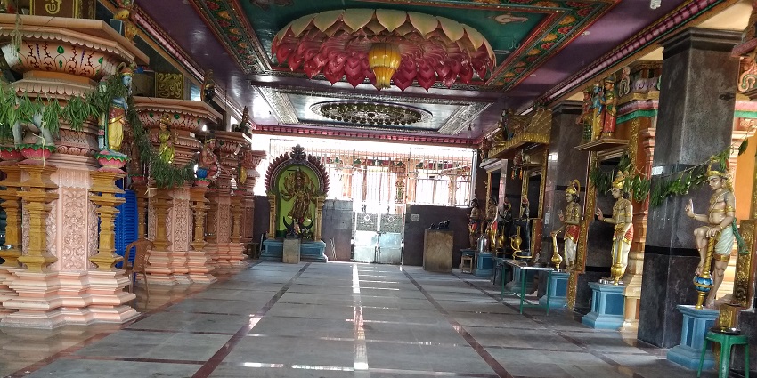 An inner view of a temple inside which various idols of gods and goddesses are present