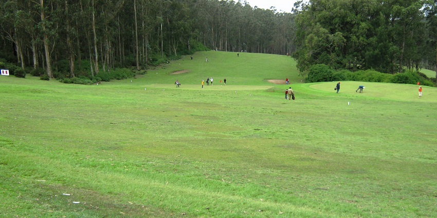 The Ooty Golf Course offers a captivating view from within, with sprawling green fairways