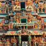 Close-up of the Intricate statues of Hindu gods adorning the colourful temple wall