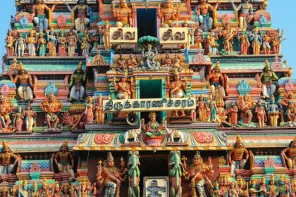 Close-up of the Intricate statues of Hindu gods adorning the colourful temple wall