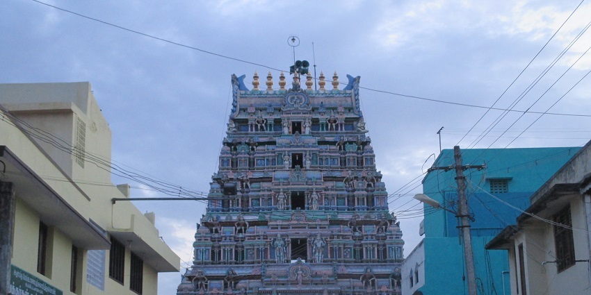 A picture of a frontal view of a temple with traditional Hindu architecture at display