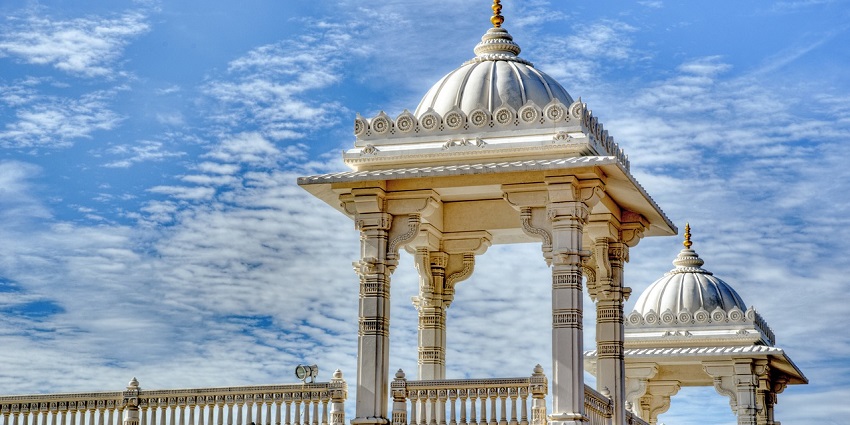 Beautiful temple in the city, showcasing intricate architecture under a bright blue sky.