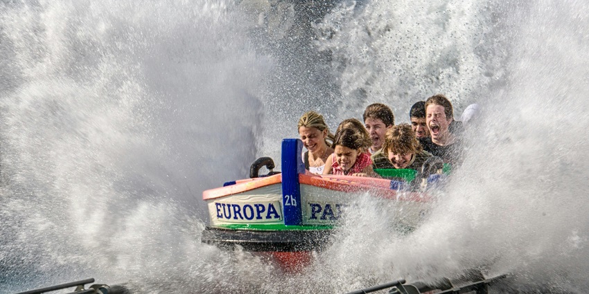 A group of people joyfully riding a water slide in one of the best water parks in Lucknow.