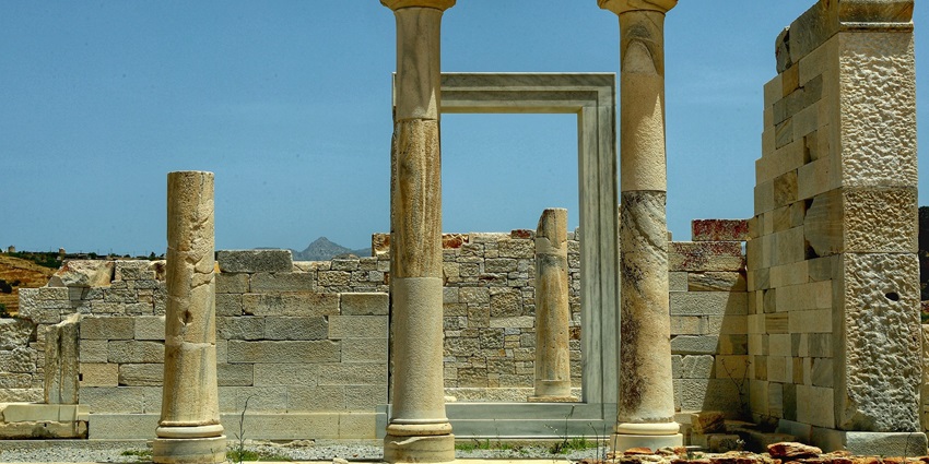 Ancient temple ruins surrounded by greenery, showcasing archaeological significance.
