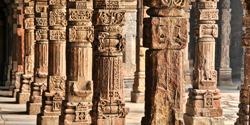 Imposing columns of a grand building, showcasing detailed architectural design and symmetry