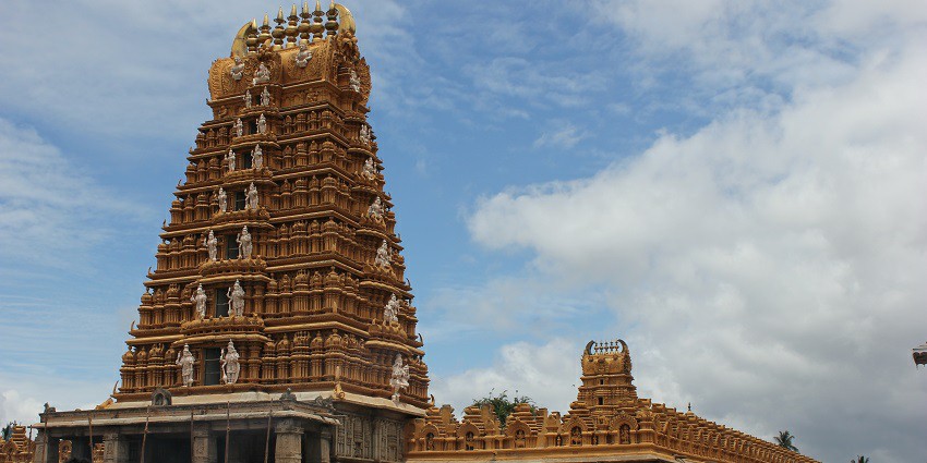 An outer view of a majestic South Indian temple showcasing its stunning architecture