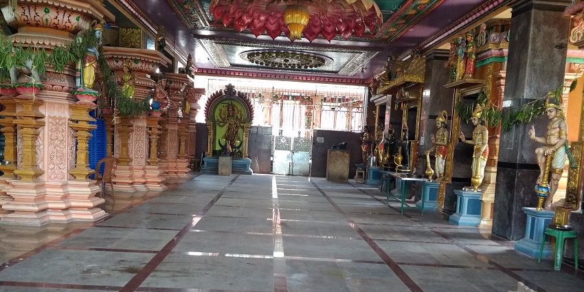 A distant view of a South Indian temple showcasing its impressive outer structure