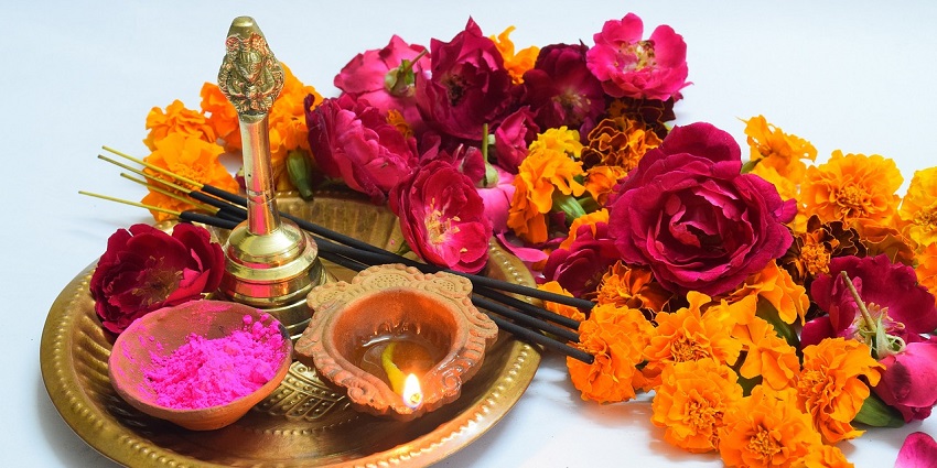 A traditionally decorated pooja thali for the hindu rituals and flowers on the side decorations