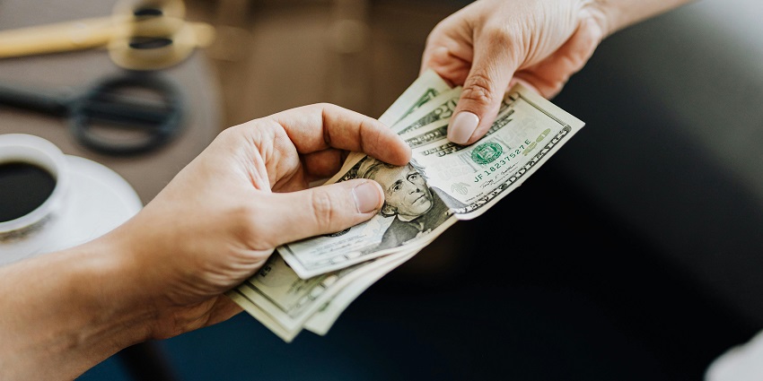 A picture of a person making a cash payment, an important consideration for a trekking trip.
