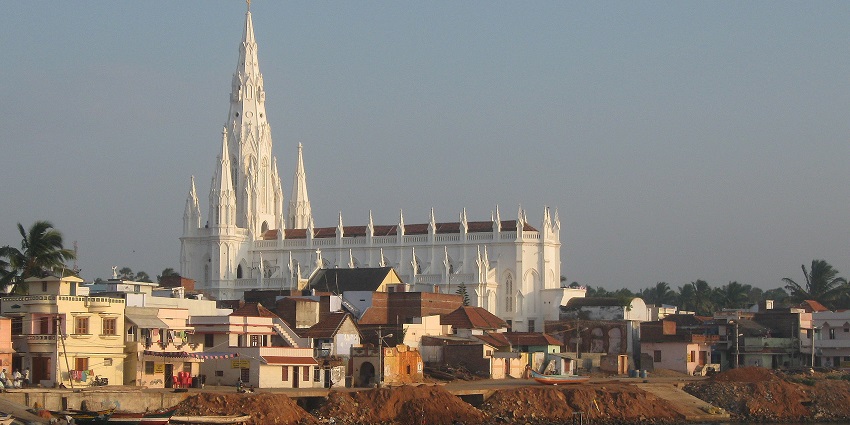 A picture of a traditionally built Church along the coast of a water body in Kerala