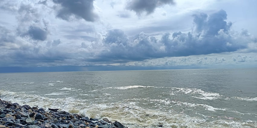 A serene view of the Tajpur Beach, a small town on the shore of the Bay of Bengal.