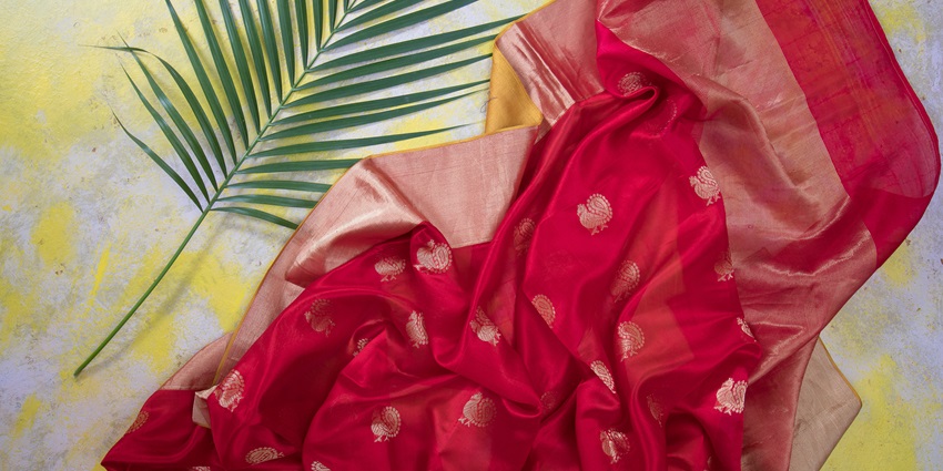 An image of the interior of PSR Silks showcasing vibrant silk sarees on display racks.
