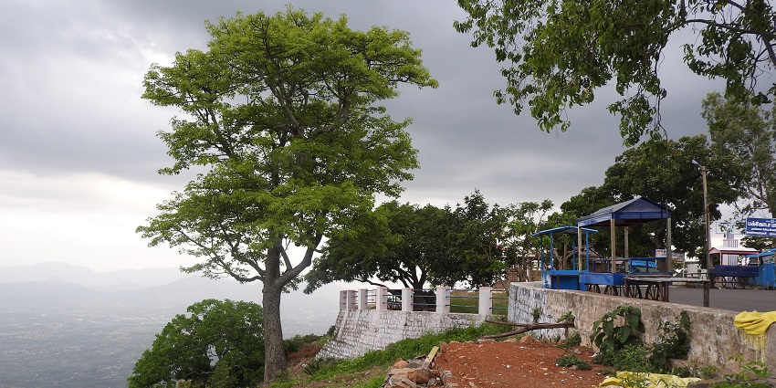 Empty movable stalls set on the Pagoda Point Hill with trees and landscape below.
