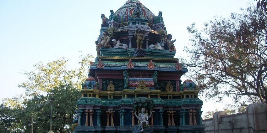 Gopuram of Palani Murugan Temple with carvings and vibrant details against the sky