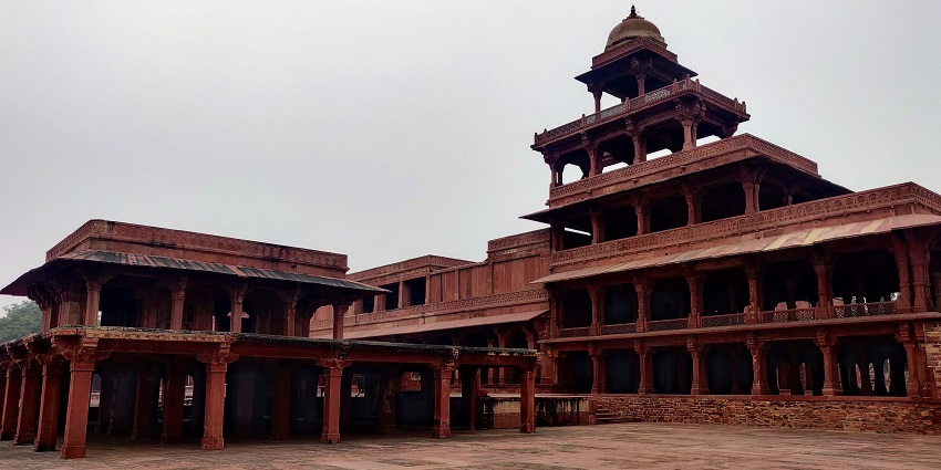 An image of Panch Mahal in Fatehpur made with red sandstone with five floors and balconies.