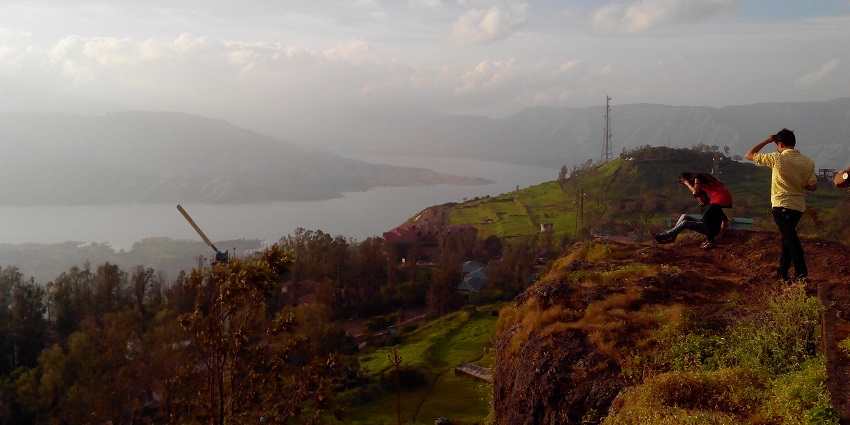 A view of Panchgani Hill station with green valleys and misty mountains.