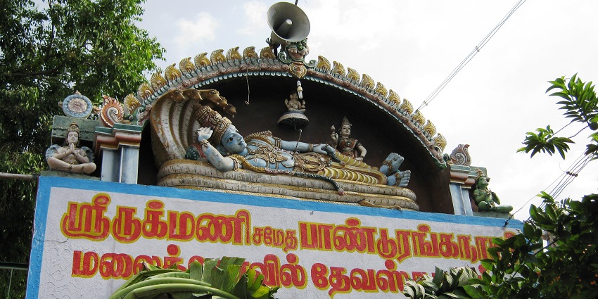 A board is showcased on the top of which there is a sculpture of Lord Vishnu on Nagraja