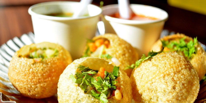 The famous street food in Nainital is hollow puris filled with tangy water, potatoes, and spices.