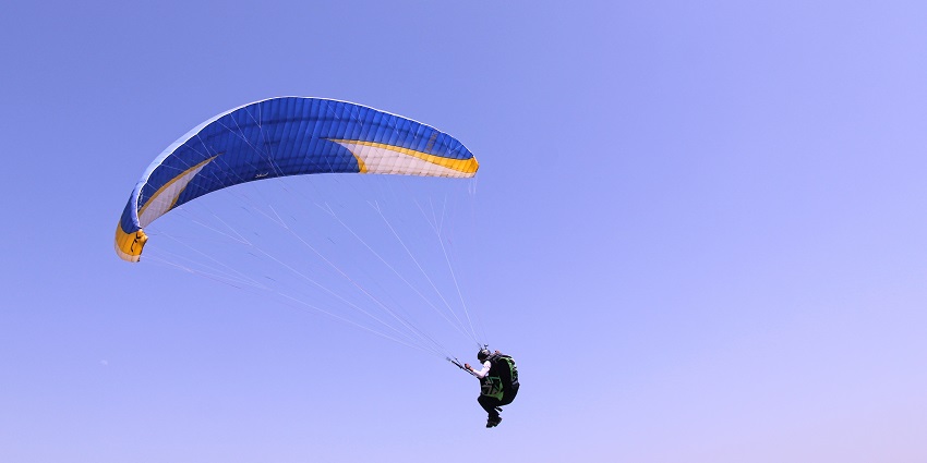 Things to do in Mukteshwar include a paragliding experience soaring above picturesque mountain scenery.
