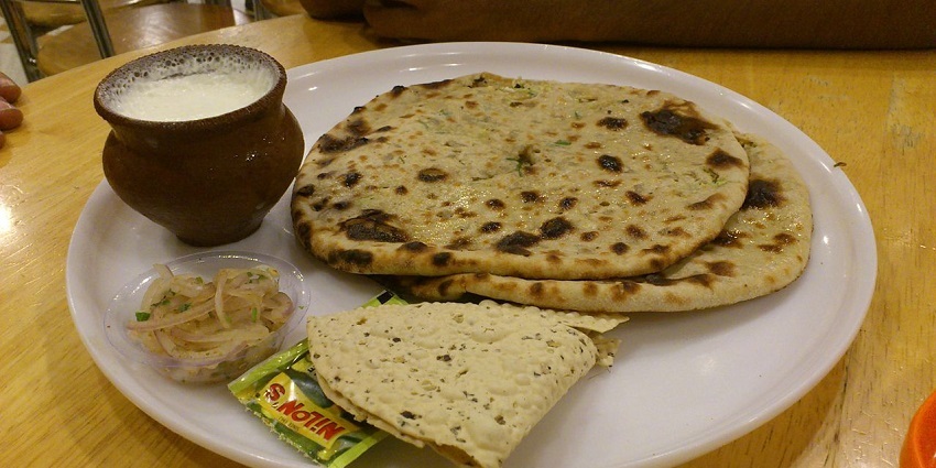 Visitors must try fluffy paranthas at Paranthe Wali Gali, the best street food in Delhi.