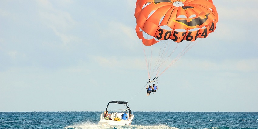 A picture of a parasailor flying over at a popular Dandi Beach water sport.