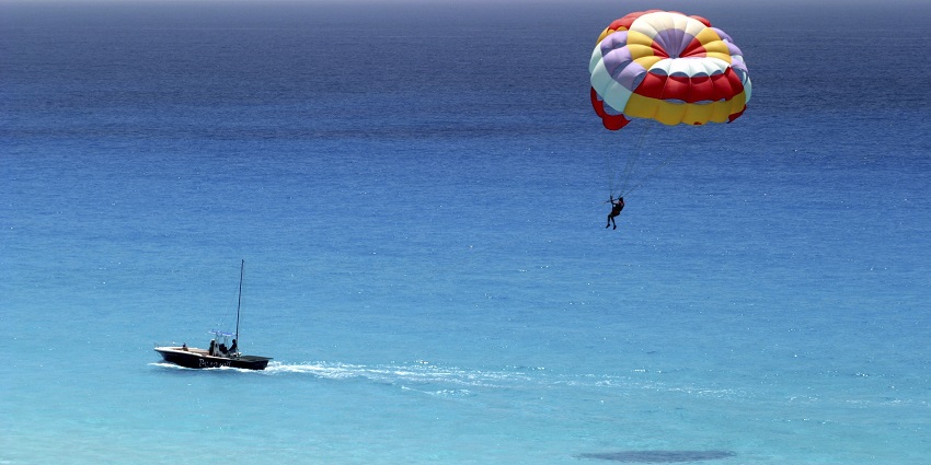 A picture of a parasailor enjoying one of the top Nagaon Beach water sports.