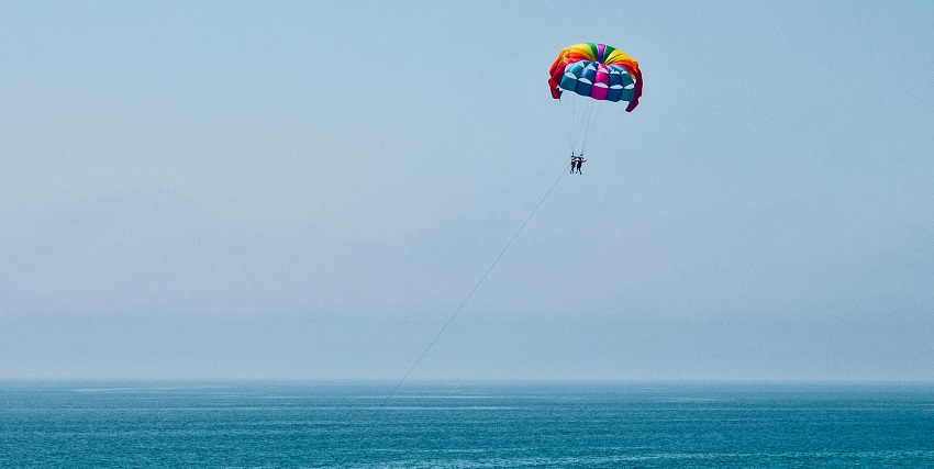 A picture of a person parasailing, one of the top water sports in Karde Beach