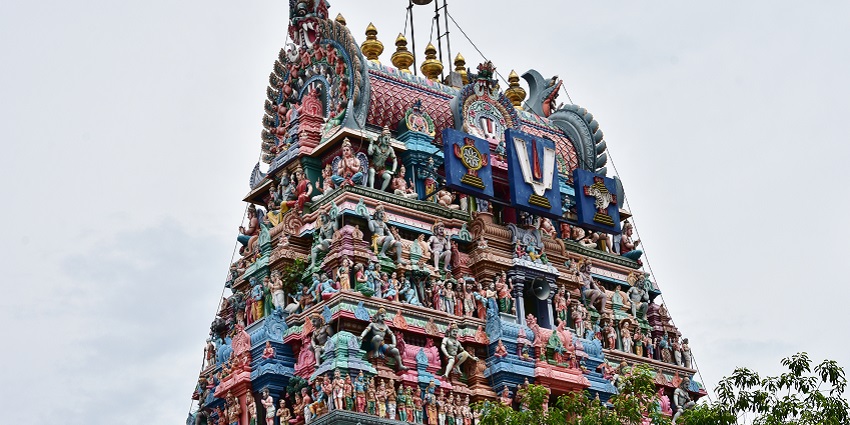 An outside upper view of the temple showcasing its vibrant stone-carved architecture