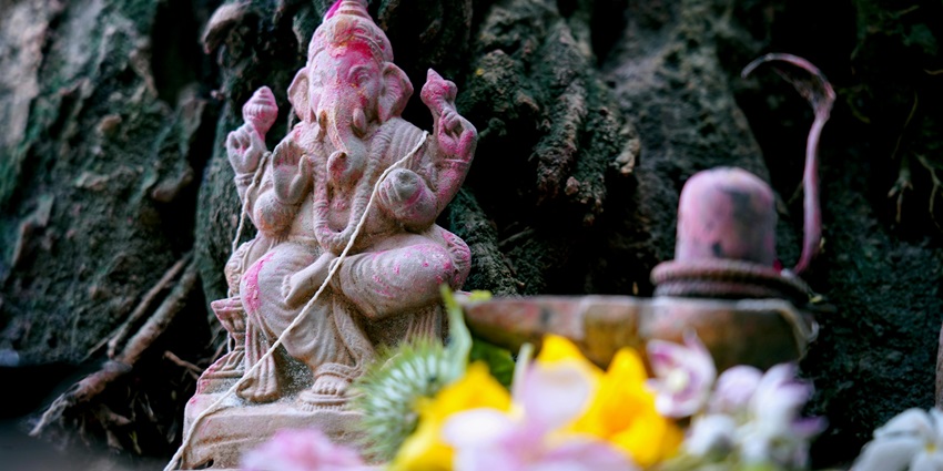 A picture of a Ganesha idol being worshipped and rituals being performed