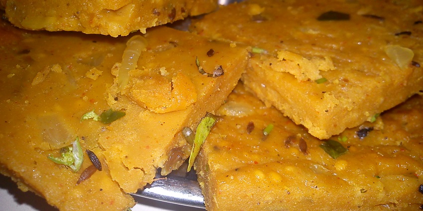 Several pieces of Patodi made up of chickpea flour and spices are served on a plate