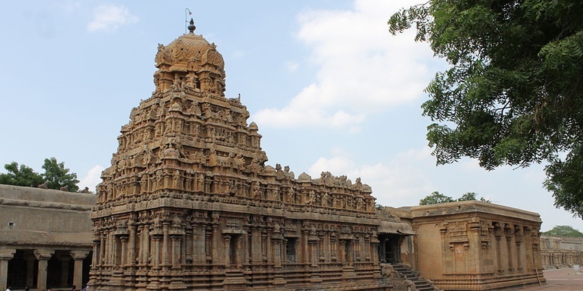 The entrance of a famous Pazhamudhir Solai, with multiple gopuram in view.