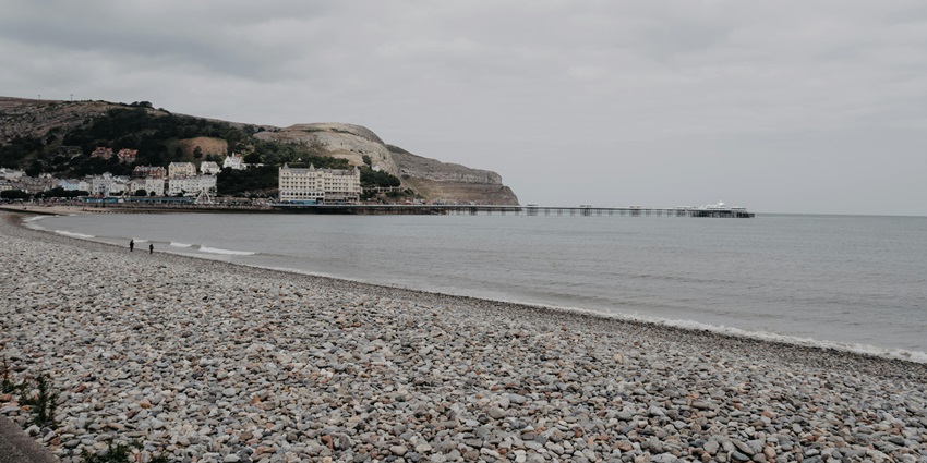 A serene beach known for its pebbled shoreline and natural beauty.