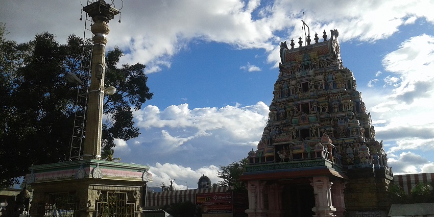 Intricately carved gopuram of Perur Pateeswarar Temple, a historic landmark near Siruvani Waterfalls.