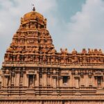 Peruvudaiyar Temple with detailed stone carvings, grand architecture and people.