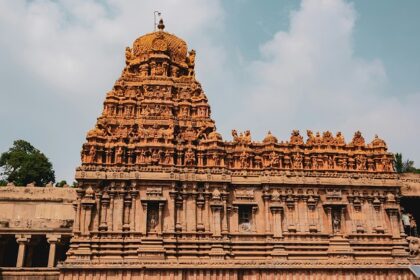 Peruvudaiyar Temple with detailed stone carvings, grand architecture and people.