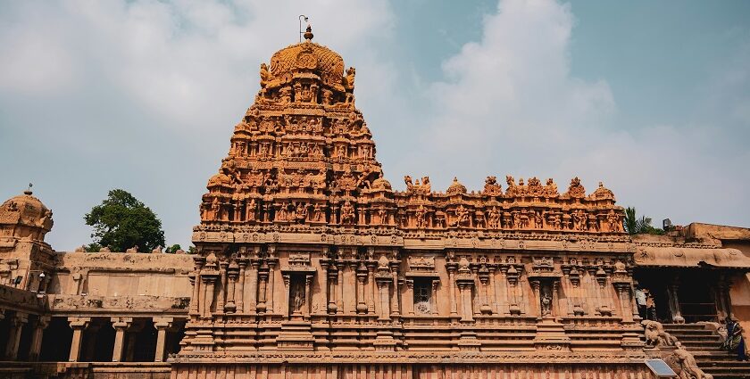 Peruvudaiyar Temple with detailed stone carvings, grand architecture and people.