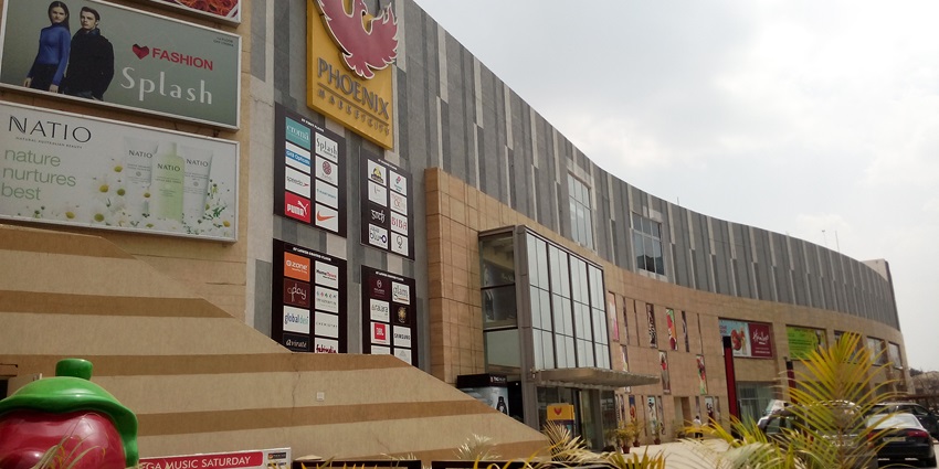 Phoenix Market City with its modern shopping complex near the Dhandeeswaram temple